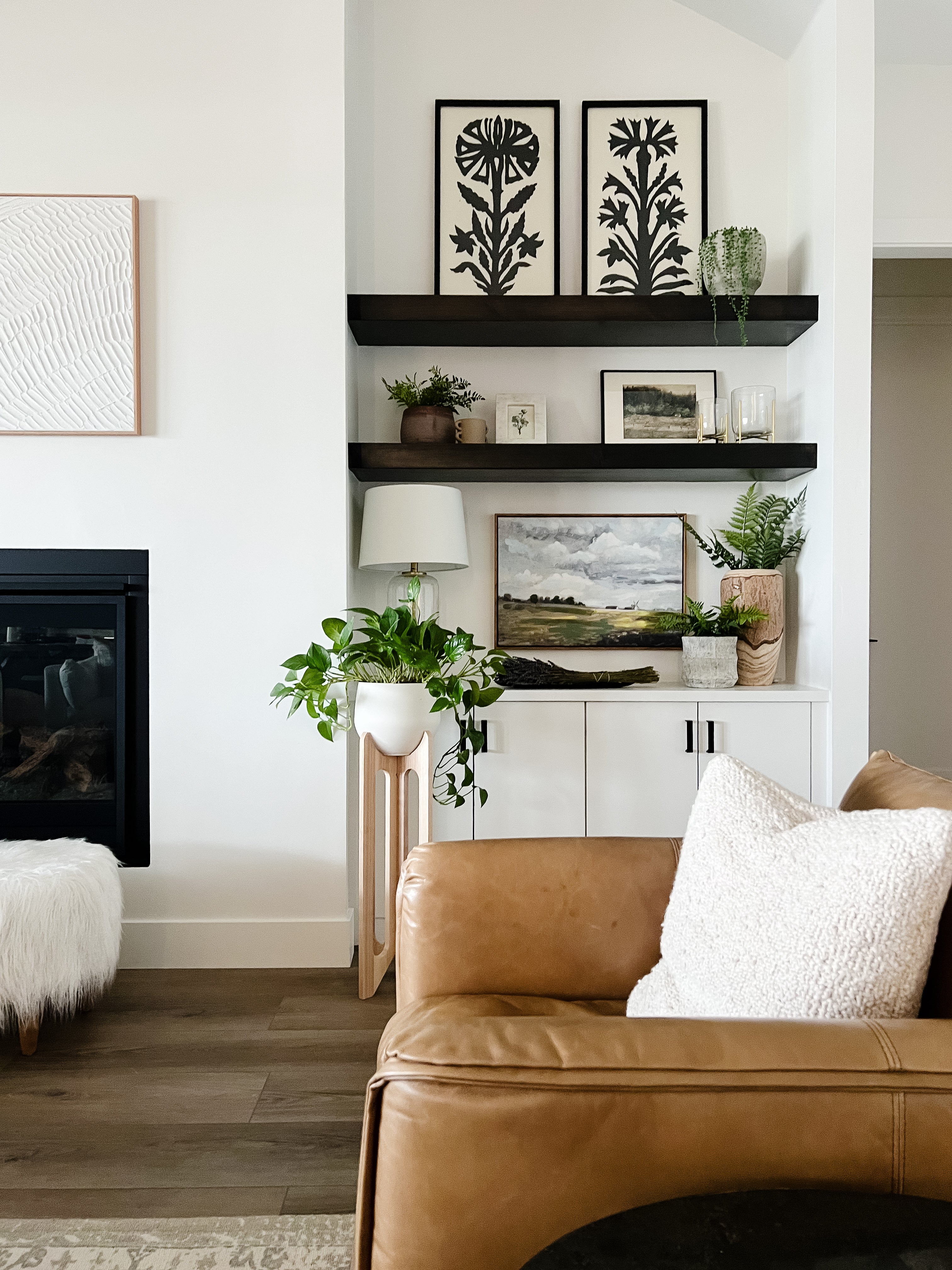 arches-plant-stand-modern-living-room-leather-couch-open-shelves-braidandwood