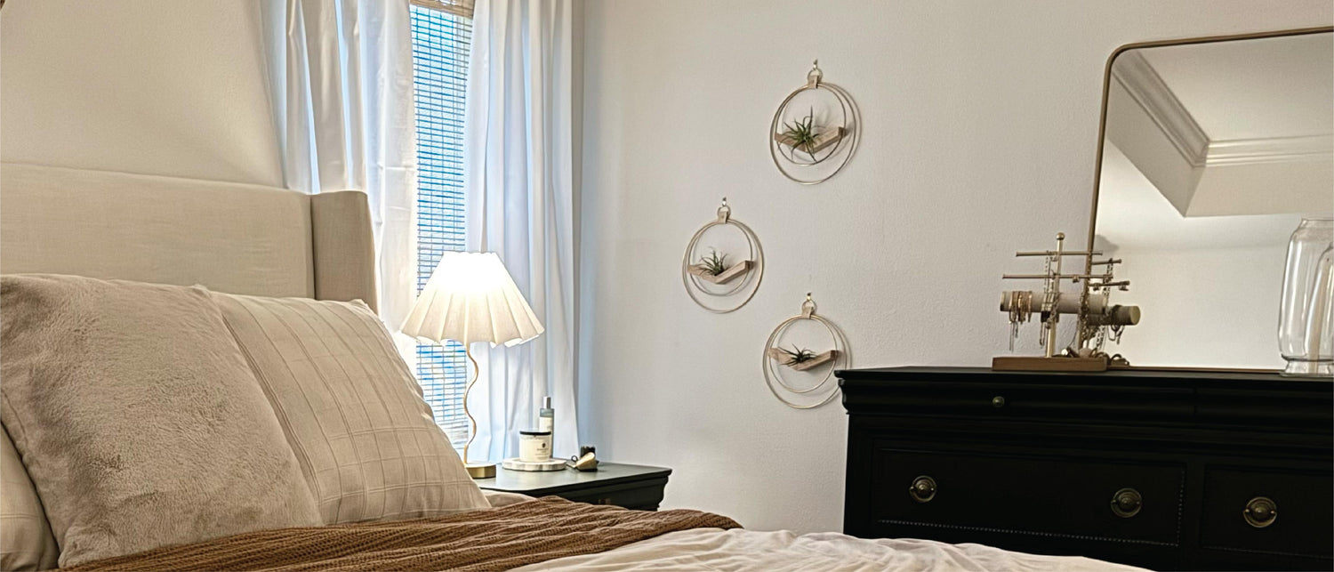 modern wall decor hanging in neutral bedroom with dark wood dresser