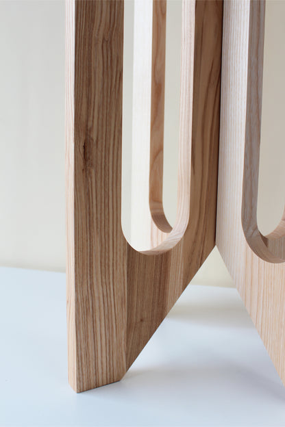 close up of base of arches wooden plant stand by braid &amp; wood