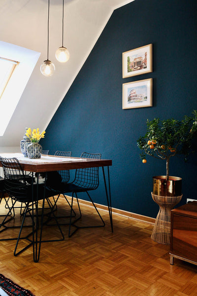 deep blue accent wall in modern living and dining area