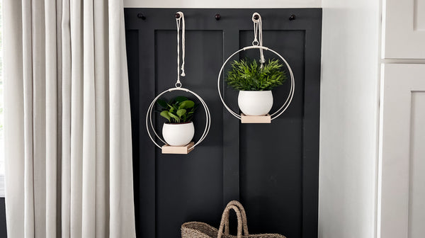 two Kandis Cottage hanging platers styled with white pots in entryway