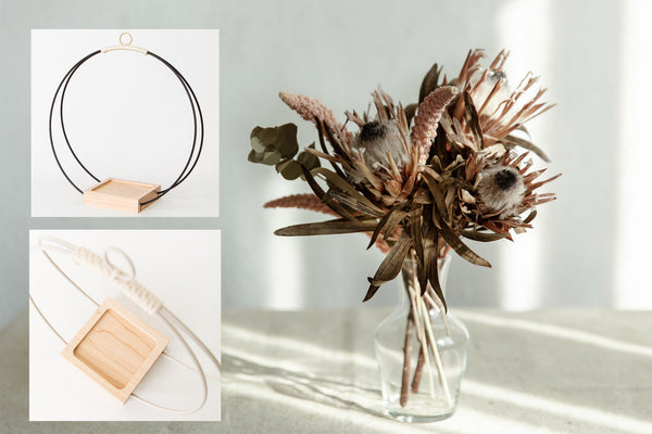 Dried floral arrangement in vase shown with hanging planter