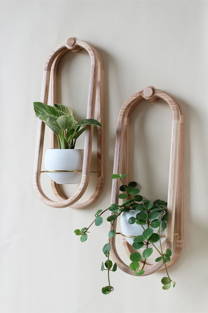modern obround wall mounted wood planter with white colored aluminum pots and houseplants