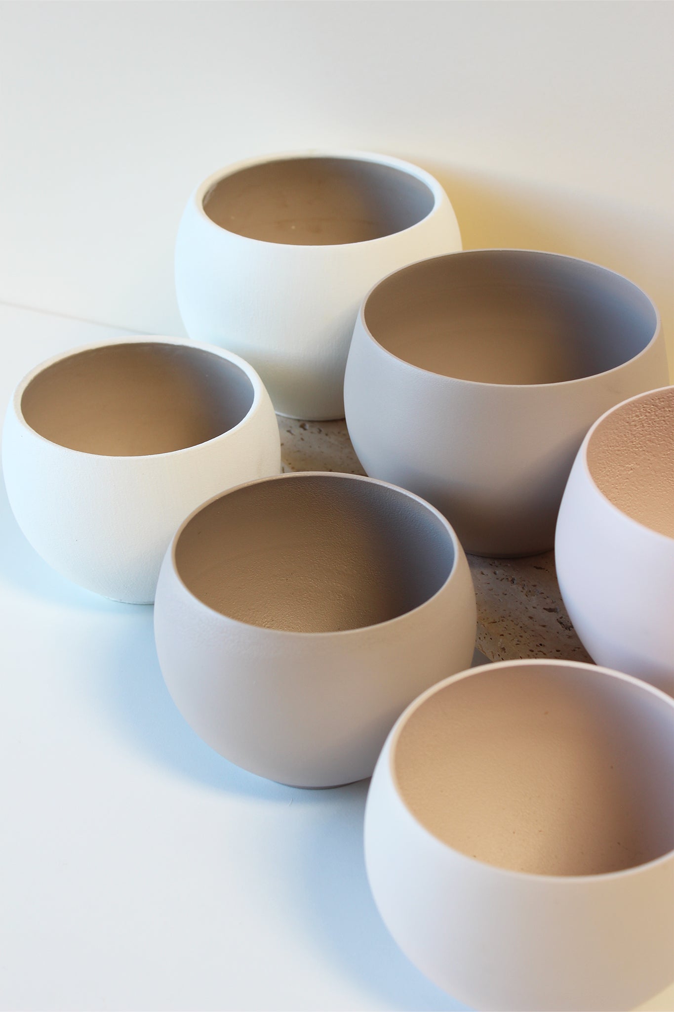 a collection of modern aluminum houseplant pots viewed from above