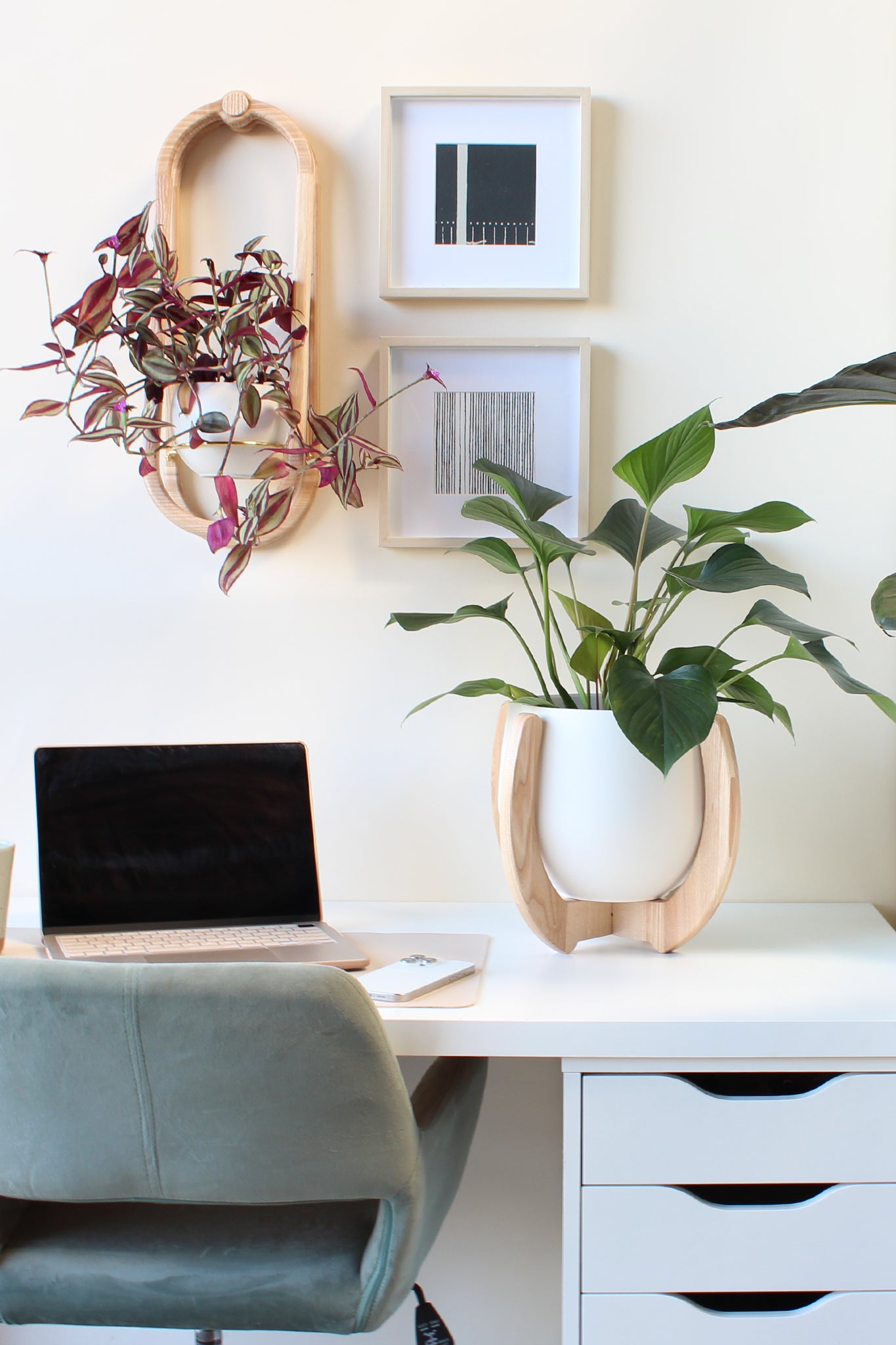 neutral home office with white desk and modern plant stand and wall planter