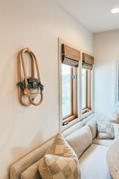 The Frame Wall Plant and spun aluminum pot on a wall in a modern breakfast nook.