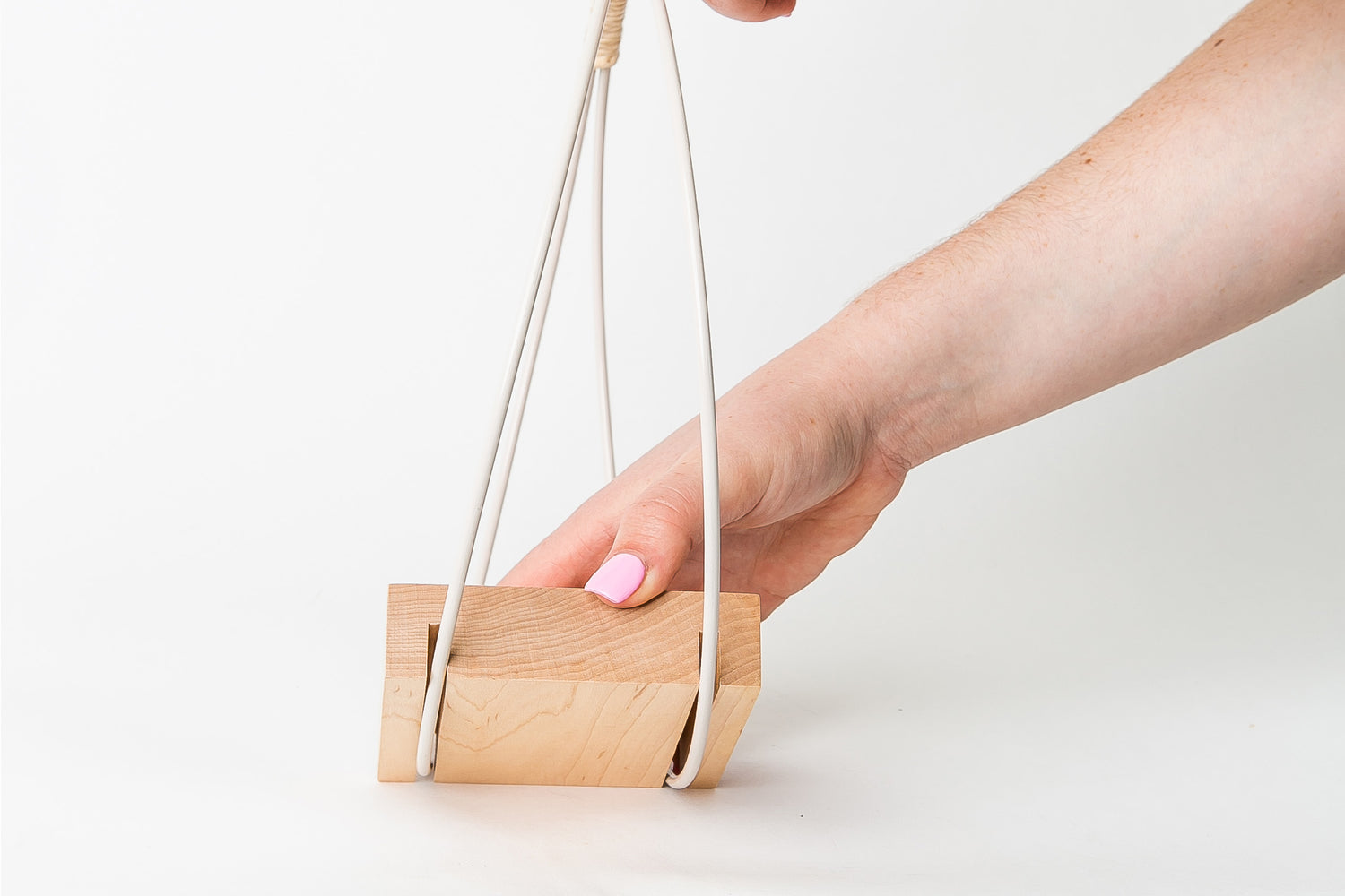 person assembling modern hanging planter