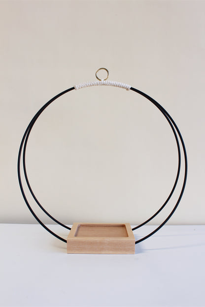 large circular hanging planter with matte black rings and no pot