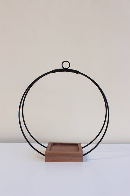 medium circular hanging planter with matte black rings, walnut wood base and no pot