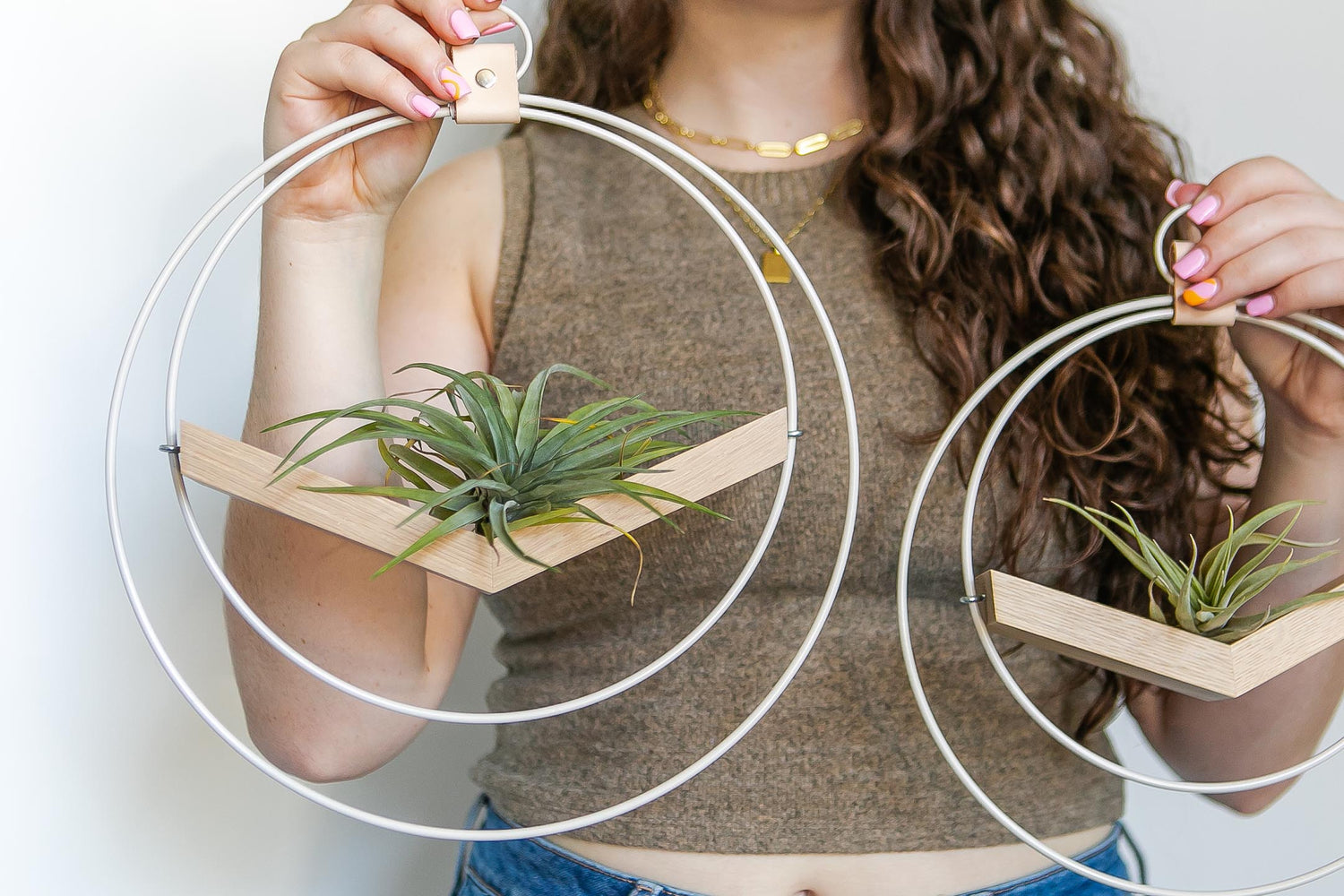 person holding two Kandis Cottage white wall mounted air plant holders